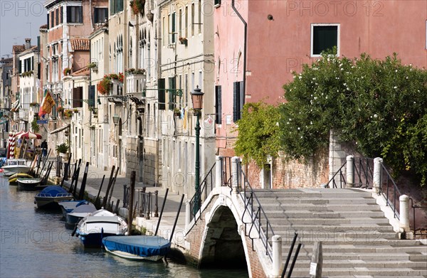 ITALY, Veneto, Venice, A bridge and colourful houses beside a canal on Fondamente della Sensa in Cannaregio district