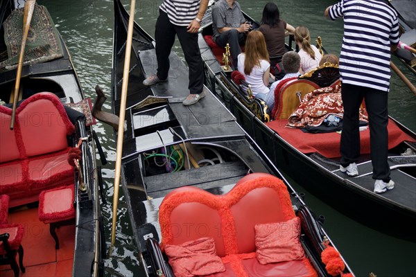 ITALY, Veneto, Venice, Gondolas with tourists passing each other closely in the narrow canals in the San Marco district