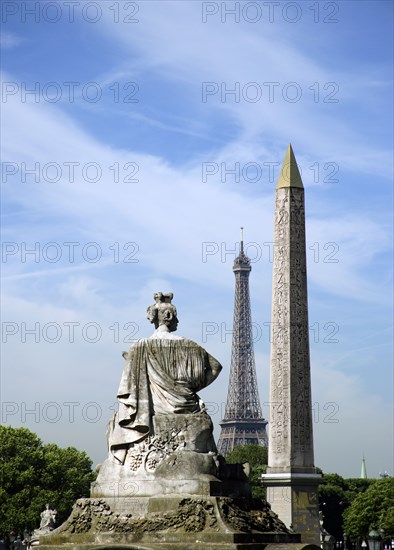 FRANCE, Ile de France, Paris, View across the Place de la Concorde showing the Obelisk and the Eiffel Tower and a sculpture representing a French city in the foreground