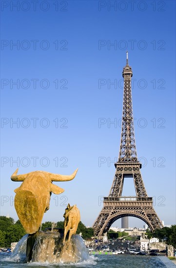 FRANCE, Ile de France, Paris, Fountain sculpture of cow and calf in the Trocadero Gardens with the Eiffel Tower beyond