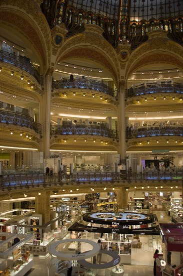 FRANCE, Ile de France, Paris, Opera Quarter. The central circular area under the glass dome of the Art Nouveau department store Galleries Lafayette showing the balconies and the perfume department on the ground floor