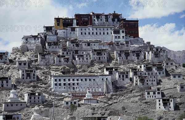 INDIA, Ladakh, Tikse Gompa, Tibetan Buddhist monastery and surrounding buildings set into steep hillside.