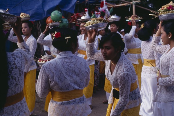 INDONESIA, Bali, Religion, Procession of women carrying food offerings to temple on occasion of temple birthday festival.