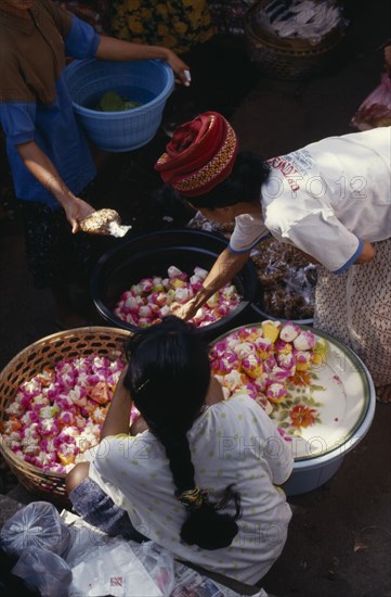 INDONESIA, Markets, Woman selling sweets from market stall.