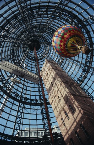 AUSTRALIA, Victoria, Melbourne, "Looking up at the old Shot Tower, hot air balloon and bi-plane inside Melbourne shopping centre."