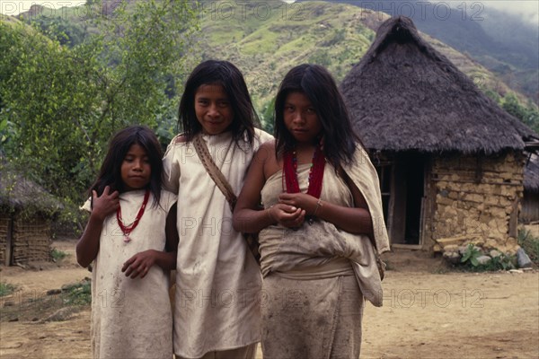 COLOMBIA, Sierra Nevada de Santa Marta, "Kogi-Wiwa children in traditional woven wool&cotton mantas cloaks  girls with red glass beads and boy with mochila shoulder bag, Avingue village on southern side of Sierra.   Tribal Indigenous Classic Classical Colombian Columbia Hispanic Historical Indegent Kids Latin America Latino Older South America "