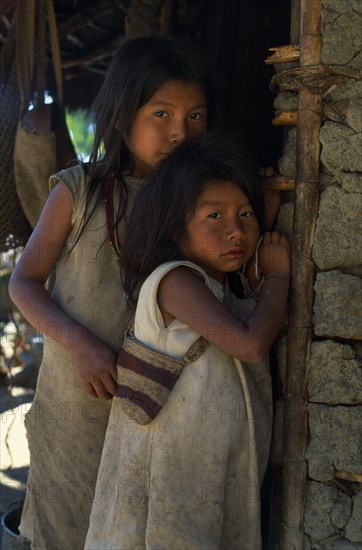 COLOMBIA, Sierra Nevada de Santa Marta, "Young Kogi-Wiwa girls in traditional dress, youngest carries baby and wears handwoven and hand-dyed fique cactus fibre mochila shoulder bag   Tribal Indigenous Babies Classic Classical Colombian Columbia Fiber Hispanic Historical Immature Indegent Latin America Latino Older South America "