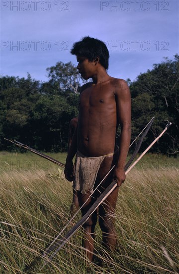 COLOMBIA, Casanare, Llanos Orientales, Cuiva Indian hunter  one of a hitherto uncontacted group  in Llanos grasslands bordering rivers Agua Clara & Casanare  with macana wood bow  bamboo arrows and beaten bark-cloth guayuko loincloth.By 2008 this group has become virtually extinct through contact with white settlers.   Tribal Indigenous 1 Colombian Columbia Hispanic Indegent Latin America Latino Single unitary South America