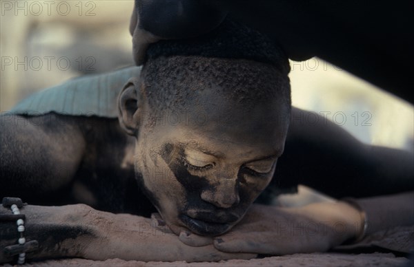 SUDAN, Rumbek, Dinka youth having hair bleached with cattle urine in Majak Asok cattle camp.