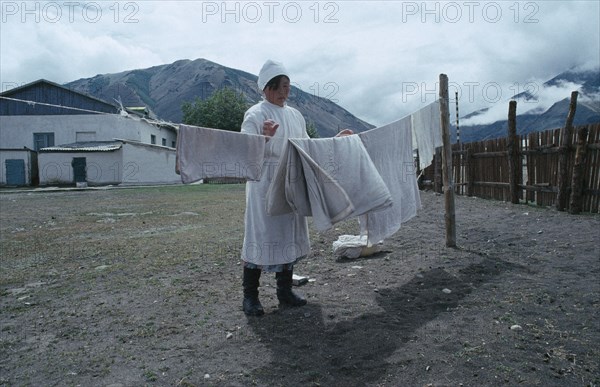 MONGOLIA, Medical, Nurse in white uniform hanging out hospital linen.