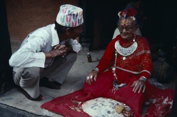 NEPAL, Patan, Man consulting oracle in Khumbe Shwar temple.