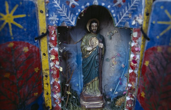 ECUADOR, Religion, Icon, Religious statuette in blue painted shrine with feathers in coloured paper.