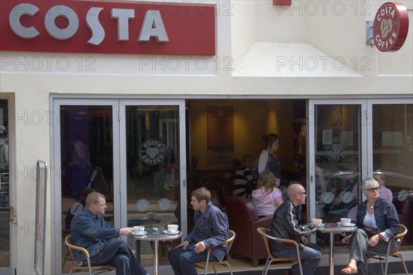 ENGLAND, East Sussex, Brighton, People sat outside the Costa coffee shop in Bond street in the North Laines area.