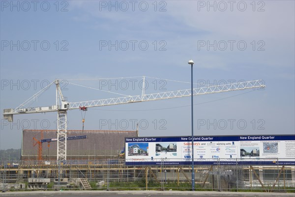 ENGLAND, East Sussex, Brighton, Construction crane in the New England quarter next to railway station.