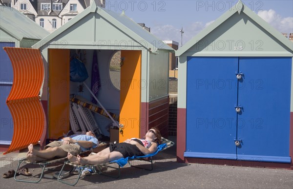 ENGLAND, East Sussex, Brighton, Colourful beach huts near Hove lagoon.