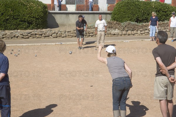 ENGLAND, East Sussex, Brighton, People playing petanque on the seafront.