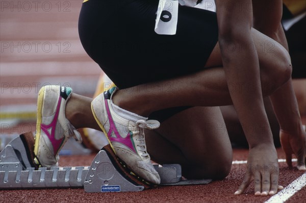 SPORT, Athletics, Male Track, Cropped view of runner on starting blocks at the start of 100 m event.