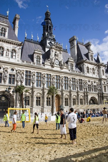 FRANCE, Ile de France, Paris, The Paris Plage urban beach. Young people playing beach football in front of the Hotel de Ville Town Hall