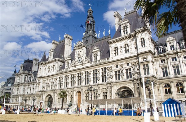 FRANCE, Ile de France, Paris, The Paris Plage urban beach. Young people playing beach rugby football in front of the Hotel de Ville Town Hall