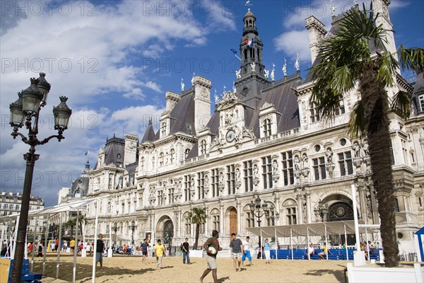 FRANCE, Ile de France, Paris, The Paris Plage urban beach. Young people playing beach rugby football in front of the Hotel de Ville Town Hall