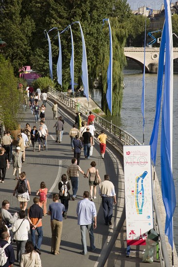 FRANCE, Ile de France, Paris, The Paris Plage urban beach. People strolling beside the River Seine along the Voie Georges Pompidou usually a busy road now closed to traffic