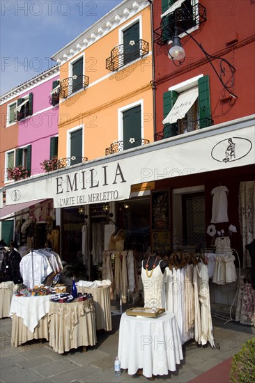 ITALY, Veneto, Venice, Brightly coloured houses above lace shops on the lagoon island of Burano the historic home of the lace making industry in the region.