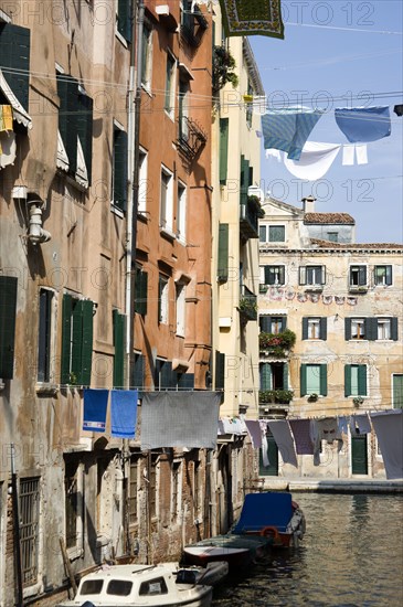 ITALY, Veneto, Venice, Washing hanging from lines above a canal from buildings in the Ghetto. The worlds first Jewish Ghetto