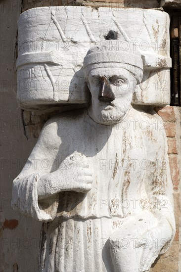 ITALY, Veneto, Venice, One of the three Mori in the Campo di Mori in the Cannaregio district. With a brass nose he depicts Signor Antonio Rioba a focus of malcious fun and satire