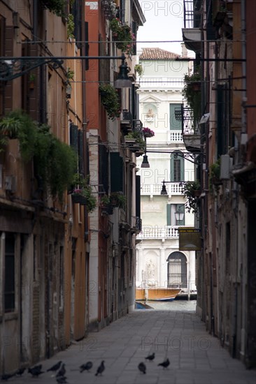 ITALY, Veneto, Venice, View down a narrow street to the Grand Canal in the San Polo and Santa Croce district