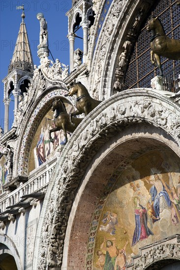 ITALY, Veneto, Venice, The bronze Horses of St Mark and the 17th Century mosaics on the facade of St Marks Basilica