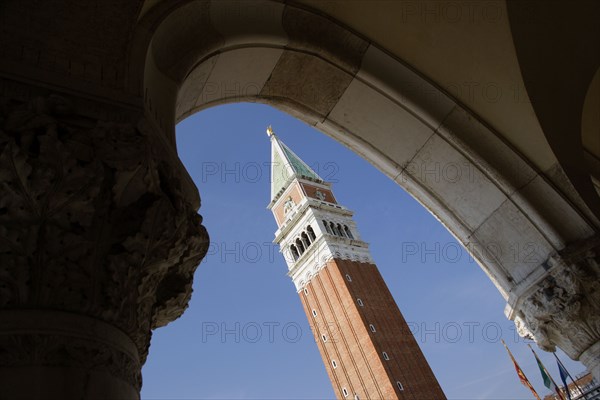 ITALY, Veneto, Venice, The Campanile in Piazza San Marco seen through an arch below the Doges Palace