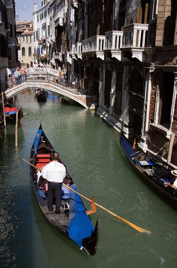 ITALY, Veneto, Venice, Gondolas with tourists passing along the Rio del Palazzo canal with its many small pedestrian bridges