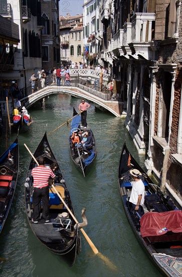 ITALY, Veneto, Venice, Gondolas with tourists passing along the Rio del Palazzo canal with its many small pedestrian bridges