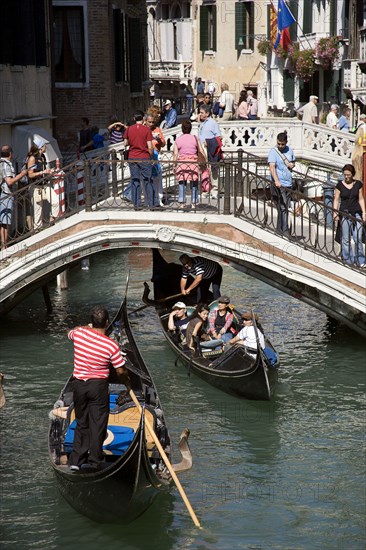 ITALY, Veneto, Venice, Gondolas with tourists passing along the Rio del Palazzo canal with its many small pedestrian bridges