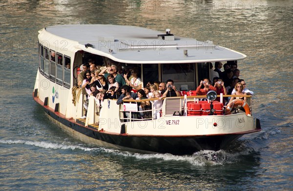 ITALY, Veneto, Venice, Sightseeing tourists aboard a Vaporetto on the Grand Canal