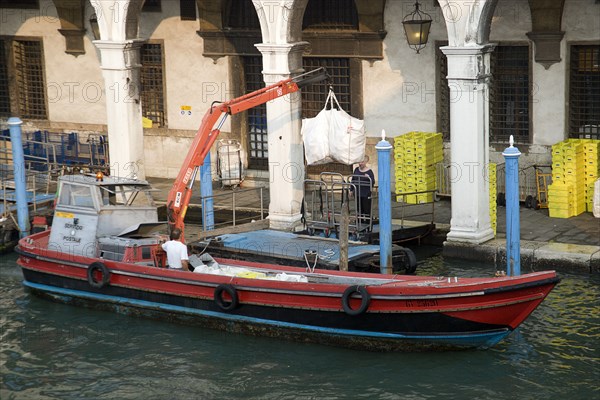 ITALY, Veneto, Venice, A postal service barge collecting mail from the main post office on the Grand Canal beside the Rialto Bridge