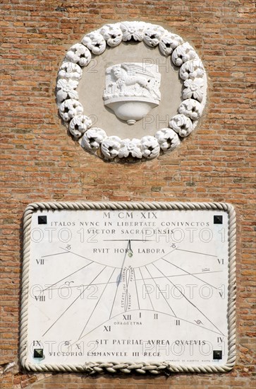 ITALY, Veneto, Venice, "A sundial on the wall of the Arsenal with year in Roman numerals and words in Latin. The crest of Venice, the winged Lion of Saint Mark, sits above."