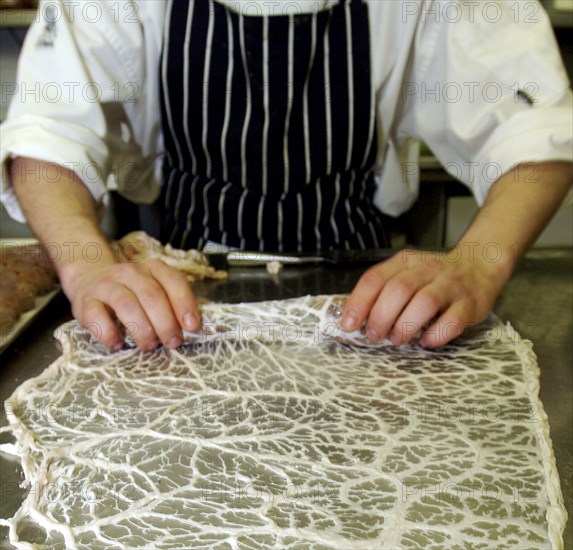 ENGLAND, Bristol, Bristol, Chef making pork sausages with coal