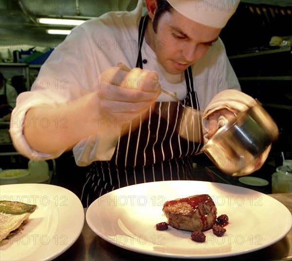 ENGLAND, Bristol, Bristol, Chef Plating Up Fillet Steak and Raspberry Coulis