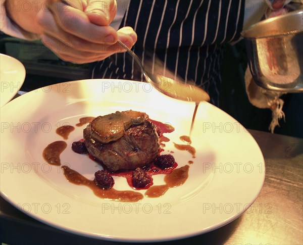 ENGLAND, Bristol, Bristol, Chef Plating Up Fillet Steak and Raspberry Coulis