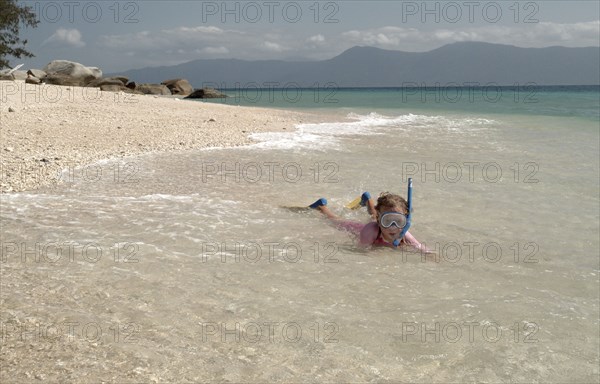 AUSTRALIA, Queensland, Fitzroy Island, Child Snorkelling on Nudie beach