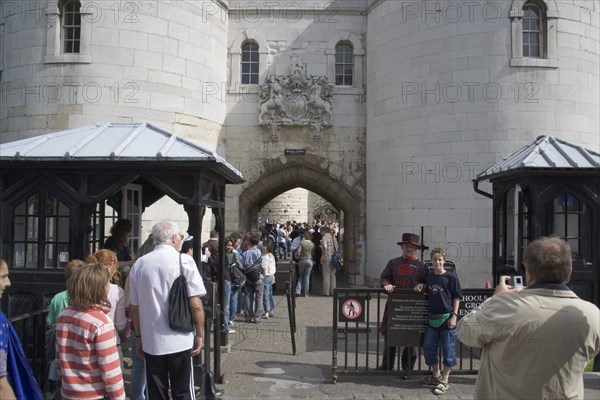 ENGLAND, London, "Tourists entering the Tower of London, yoing boy having his picture teken with a Yoeman Warder or Beefeater."