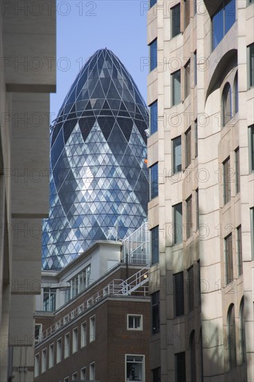 ENGLAND, London, "Detail of the top of the Gherkin Swiss RE Building, 30 St Mary Axe, seen through narrow city street. Designed by Architect Sir Norman Foster."