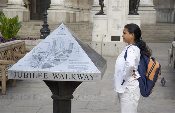 ENGLAND, London, Tourist consulting map outside the Bank of England in  Threadneedle Street.