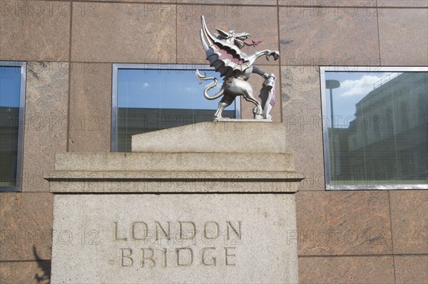 ENGLAND, London, London Bridge detail with statue of Griffin on the Southwark side. Griffins mark the historical city boundary and are where travellers paid their tolls.