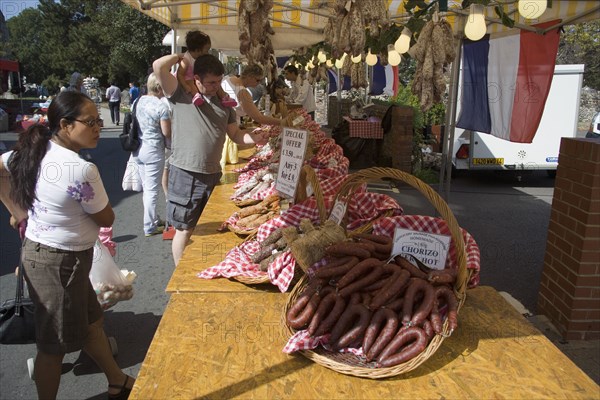 ENGLAND, West Sussex, Shoreham-by-Sea, French Market. Selection of sausages and cured meat on display in baskets on stall