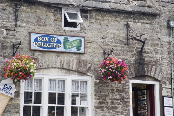 ENGLAND, Dorset, Corfe, Detail of an Ice Cream Parlour in a traditional cottage with hanging baskets