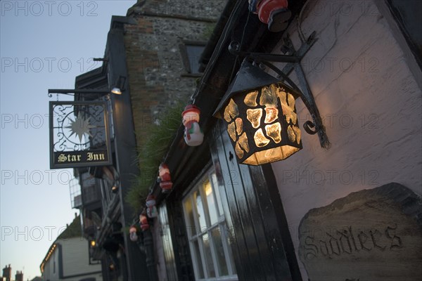 ENGLAND, East Sussex, Alfriston, Lantern and sign outside the Star pub.