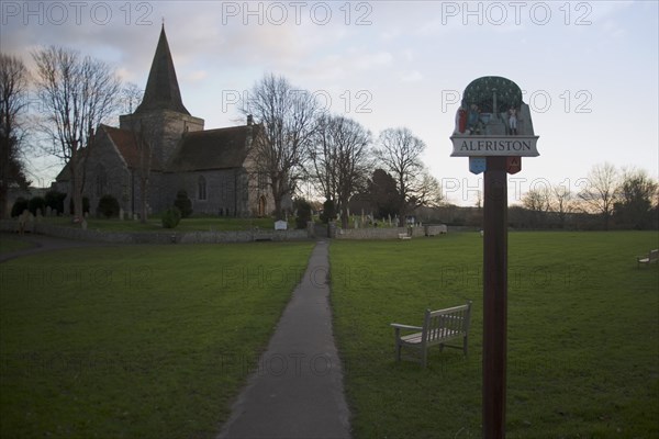 ENGLAND, East Sussex, Alfriston, St Andrew’s church in a warm evening light.