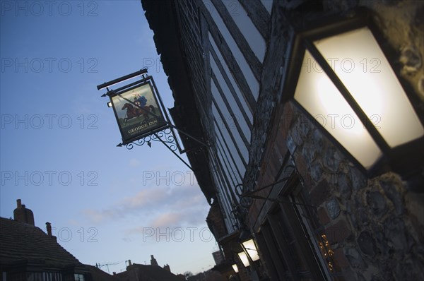 ENGLAND, East Sussex, Alfriston, Lantern and sign outside the George Inn pub in the high street.
